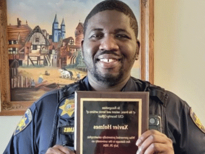 CIU Security Officer Xavier Holmes displays his plaque. 